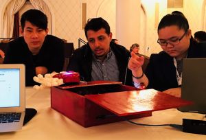 City Tech students Jiaman Zhao, Mohamed Alborati, and Teddie Lai demonstrate the movements they programmed into the prosthetic hand they created, and the sensor data they utilize during a breakfast round table at the 2017 ATE Principal Investigators Conference.  (Photo by Madeline Patton)  