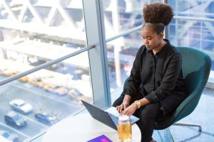 A woman works on her laptop in an office