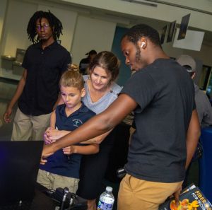 An Indian River State College student demonstrates a quantum eraser at a community event. 