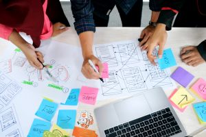 A photo of a table with graphic organizers and post-it notes