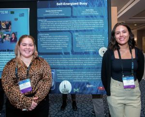 Skylre Hine, left, and teammate Diandra Dietrich-Celotto, explain the operation of their self-energizing buoy.