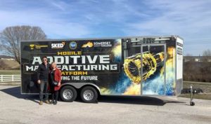 Eric Wooldridge and Sheri McGuffin use the trailer purchased with ATE grant funds to promote additive manufacturing.